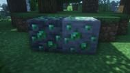 Emerald ore next to its deepslate variant (Image via Minecraft)